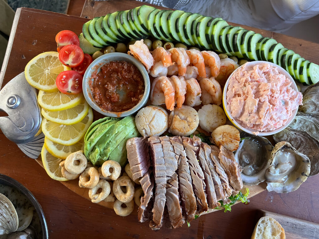 seacuterie board with an assorment of seafoods and veggies
